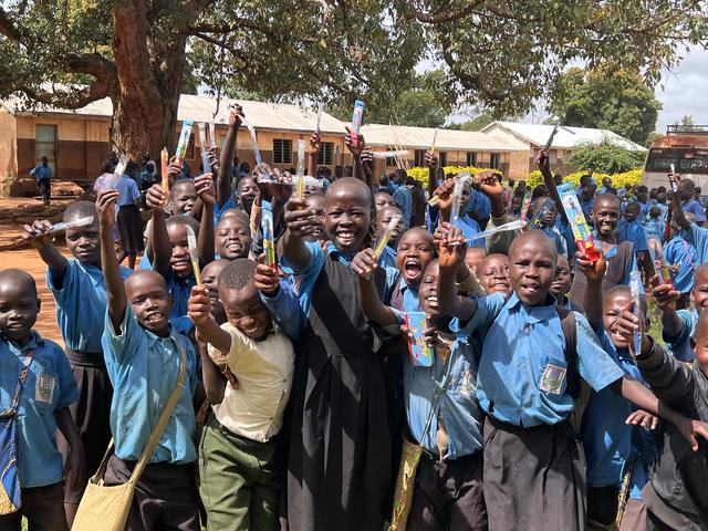 Pupils celebrating with their new toothbrushes